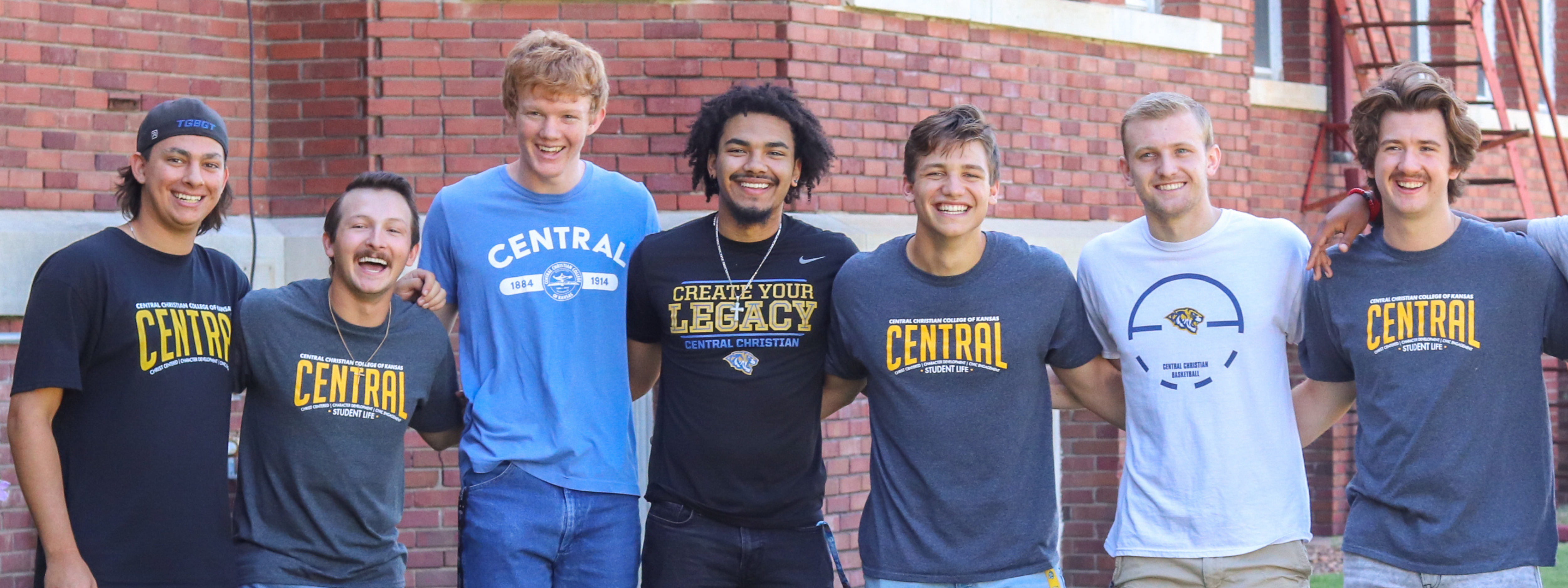 Psychology Photo Header: Central boys standing in a line smiling and laughing