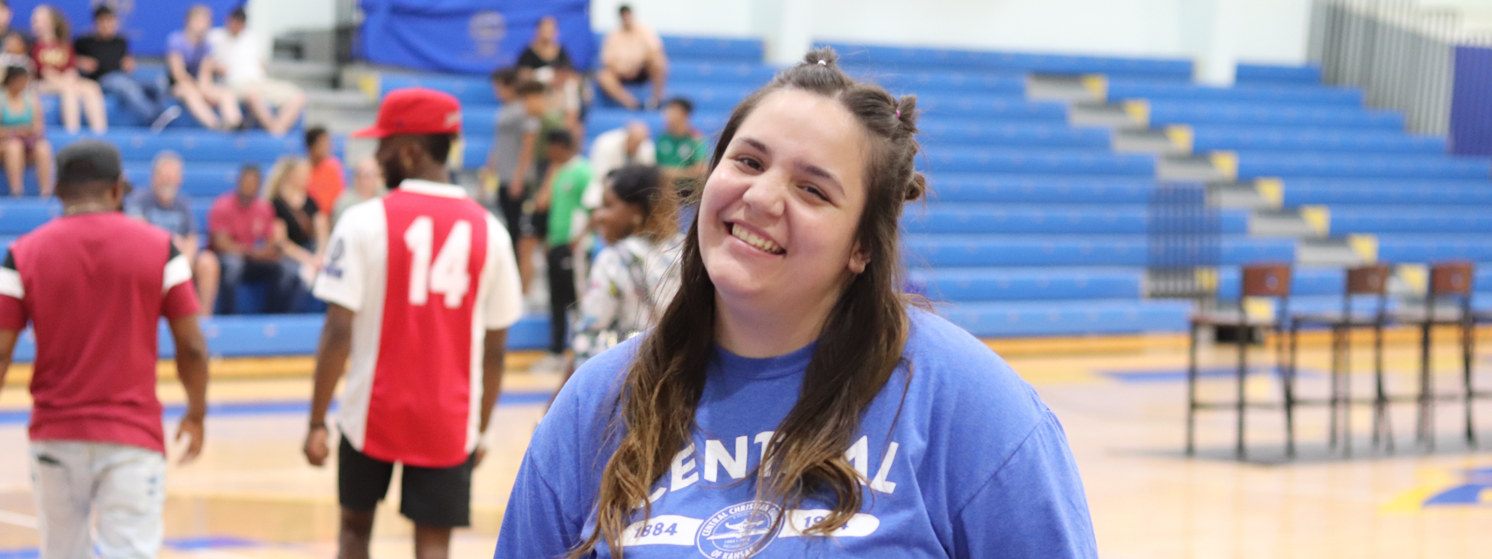 Health Sciences Photo Header: Central student standing and smiling in the gym